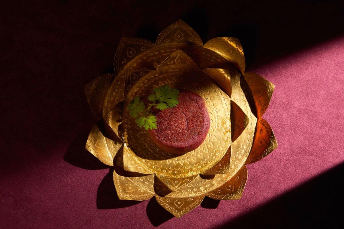 a gold flower with a plant in the middle at JW Marriott Mumbai Juhu in Mumbai