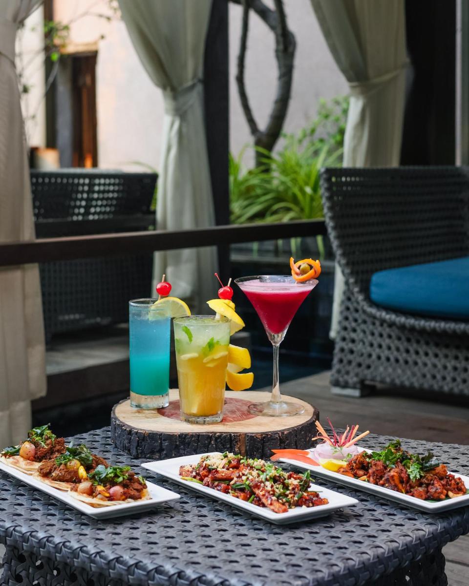 a table with three plates of food and drinks at Hilton Chennai in Chennai