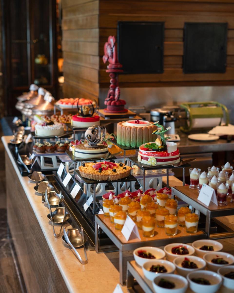 a buffet line with different types of desserts and pastries at Hilton Chennai in Chennai