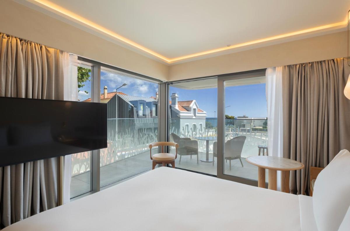 Uma cama ou camas num quarto em EVOLUTION Cascais-Estoril Hotel
