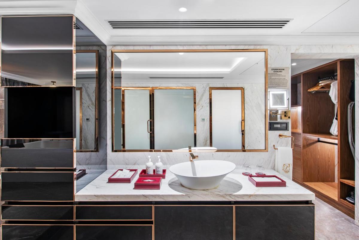 a bathroom with a sink and a large mirror at Radisson Blu Hotel & Suites GRT Chennai in Chennai