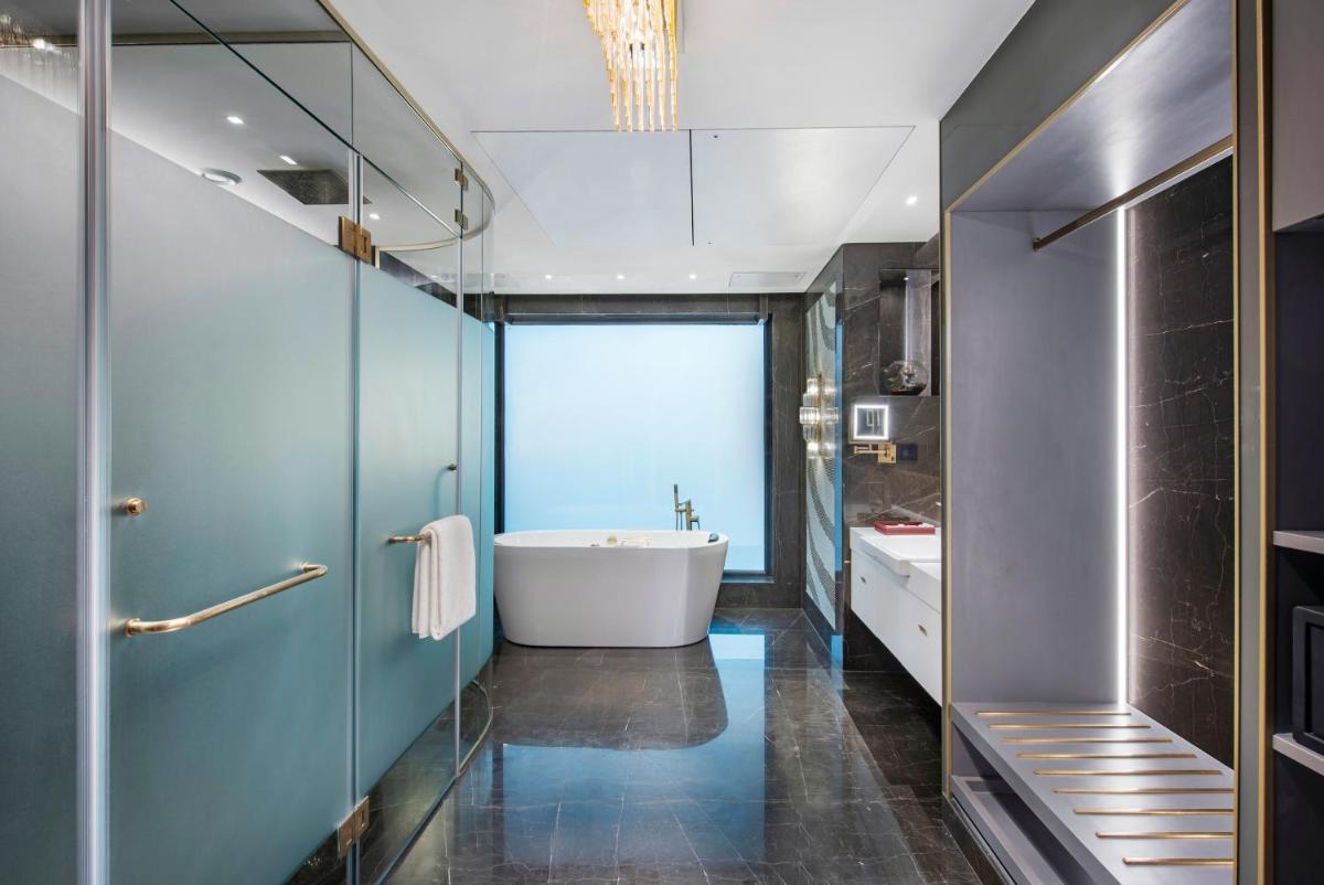a bathroom with a tub and a sink at Radisson Blu Hotel & Suites GRT Chennai in Chennai