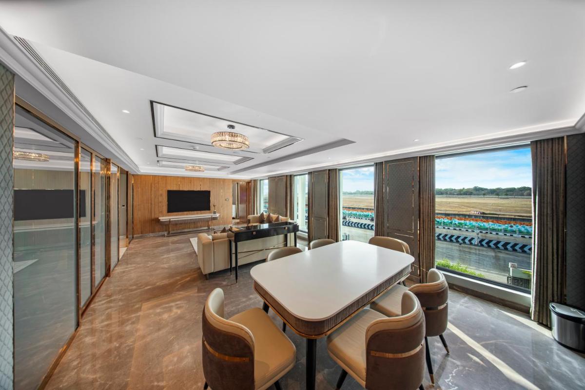 a conference room with a table and chairs and windows at Radisson Blu Hotel & Suites GRT Chennai in Chennai