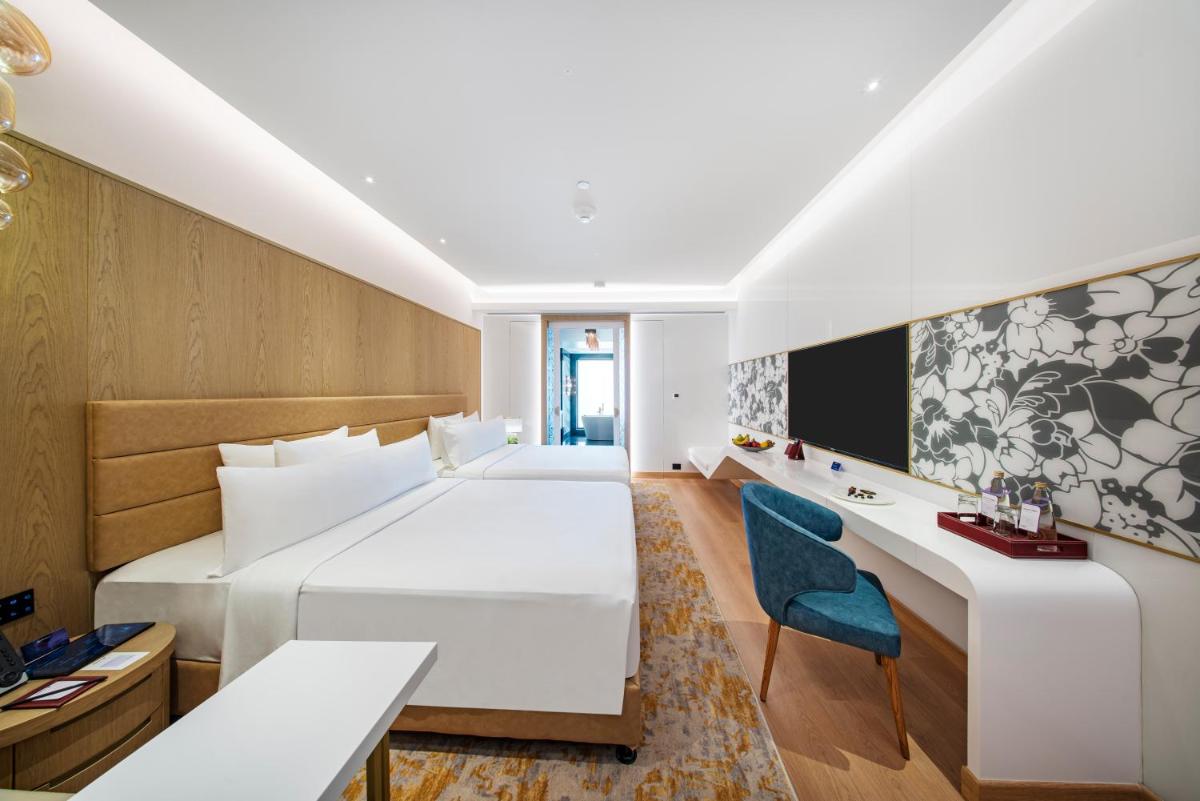 a hotel room with a bed and a desk at Radisson Blu Hotel & Suites GRT Chennai in Chennai