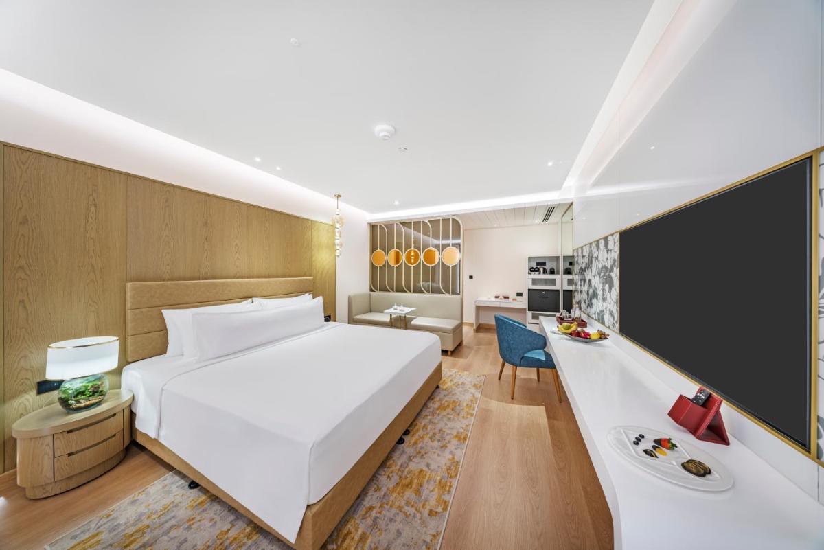 a hotel room with a bed and a desk at Radisson Blu Hotel & Suites GRT Chennai in Chennai