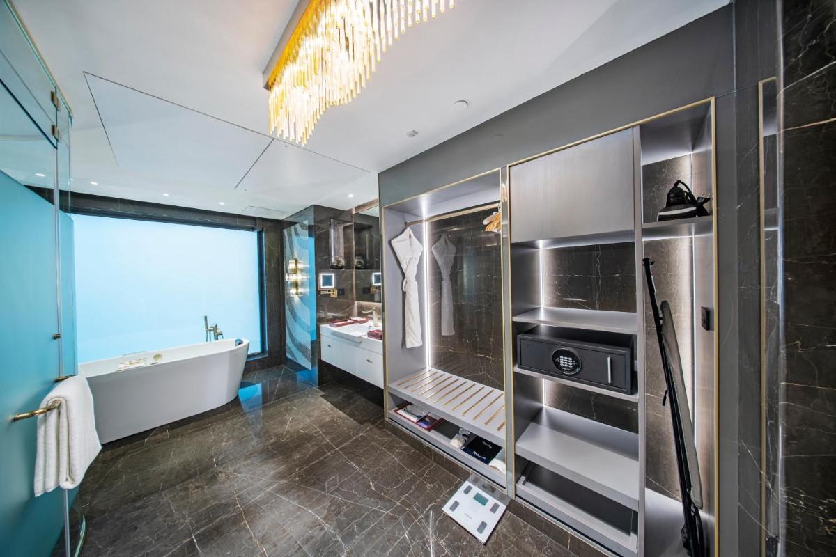 a bathroom with a tub and a sink at Radisson Blu Hotel & Suites GRT Chennai in Chennai