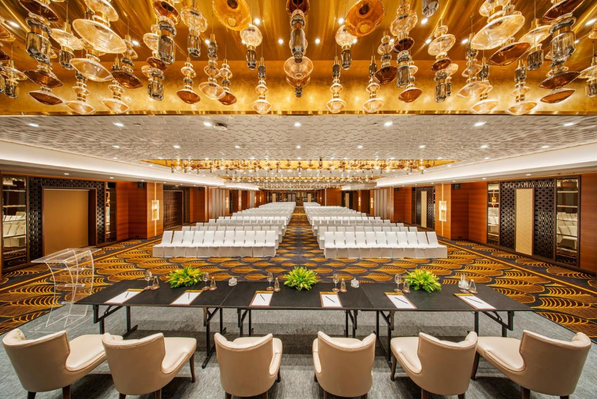 a large banquet hall with a large table and chairs at Radisson Blu Hotel & Suites GRT Chennai in Chennai