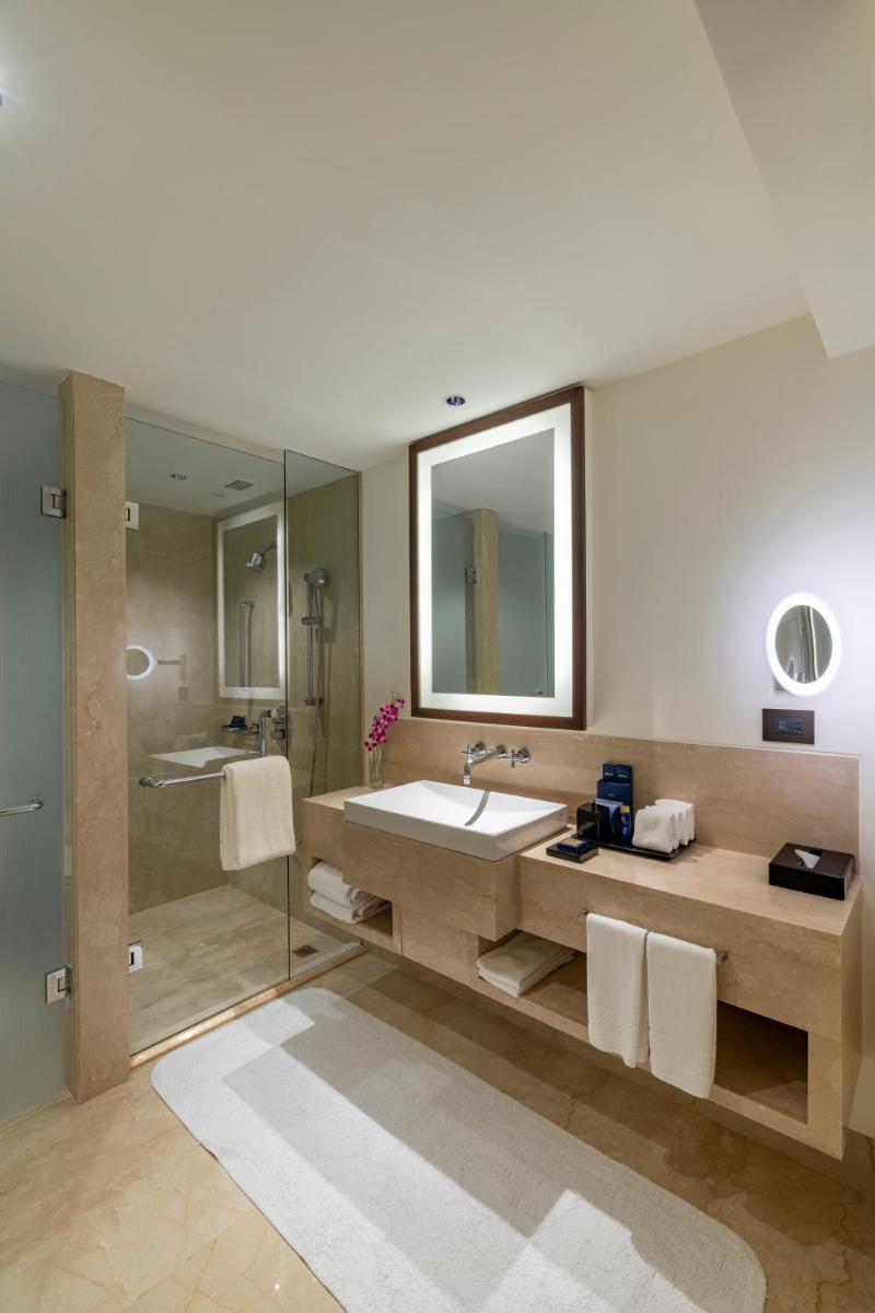 a bathroom with a large sink and a shower at The Oberoi Mumbai in Mumbai