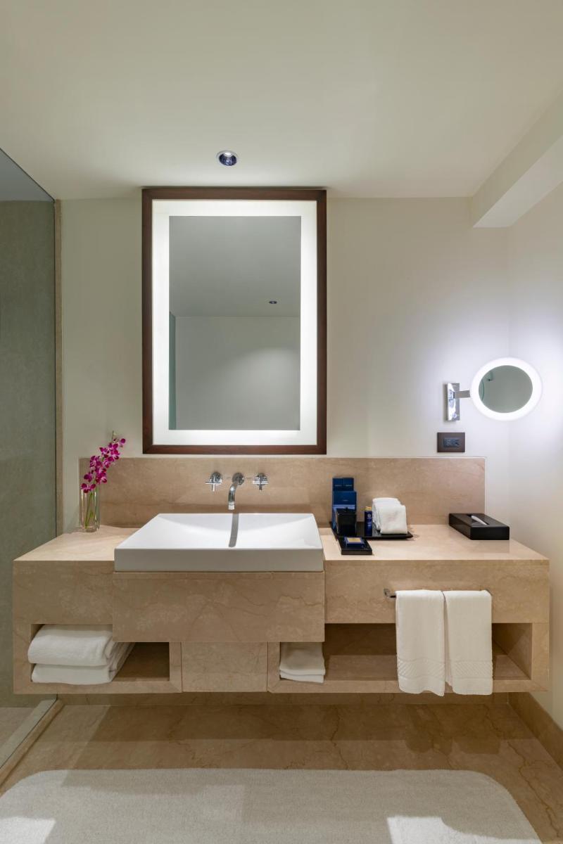 a bathroom with a large sink and a window at The Oberoi Mumbai in Mumbai