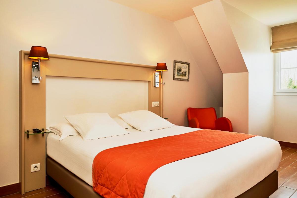 Un ou plusieurs lits dans un hébergement de l'établissement Hotel Spa Les Saules