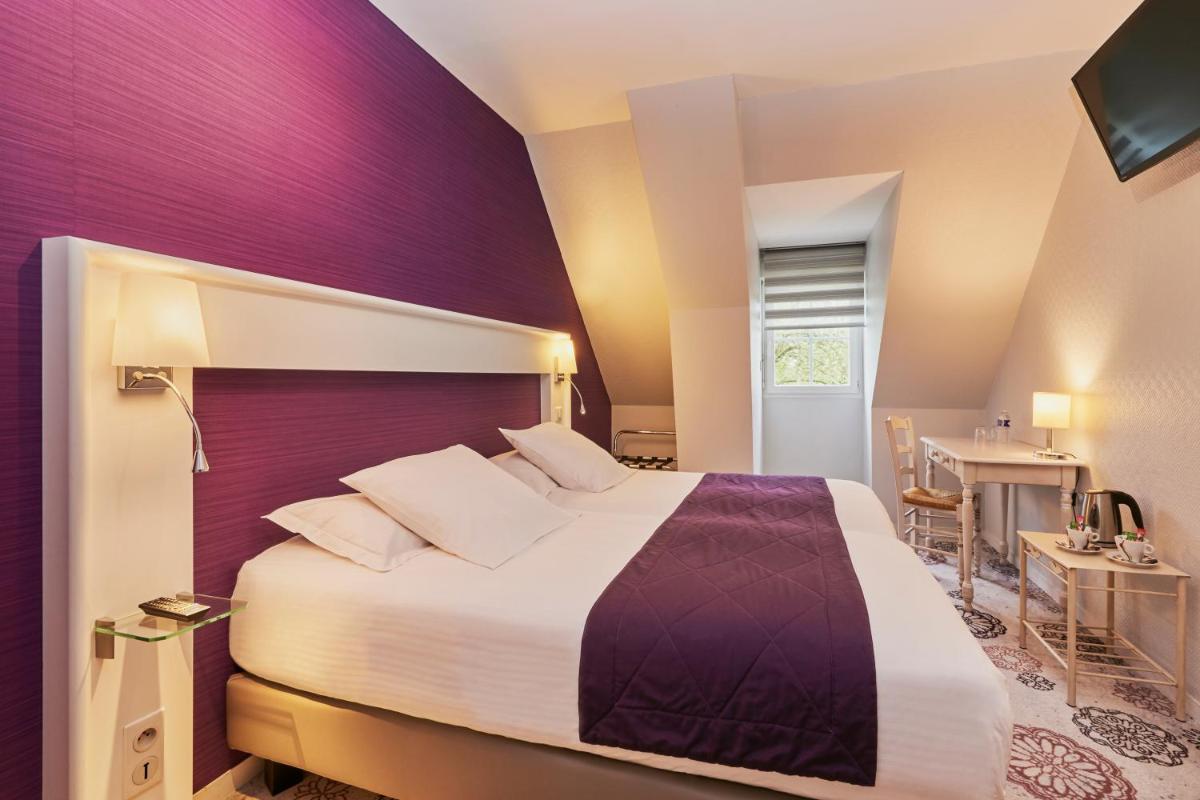 Un ou plusieurs lits dans un hébergement de l'établissement Hotel Spa Les Saules