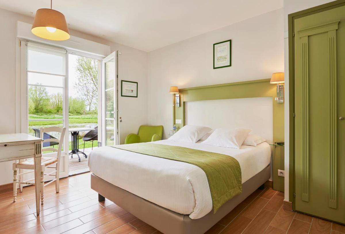 Un ou plusieurs lits dans un hébergement de l'établissement Hotel Spa Les Saules