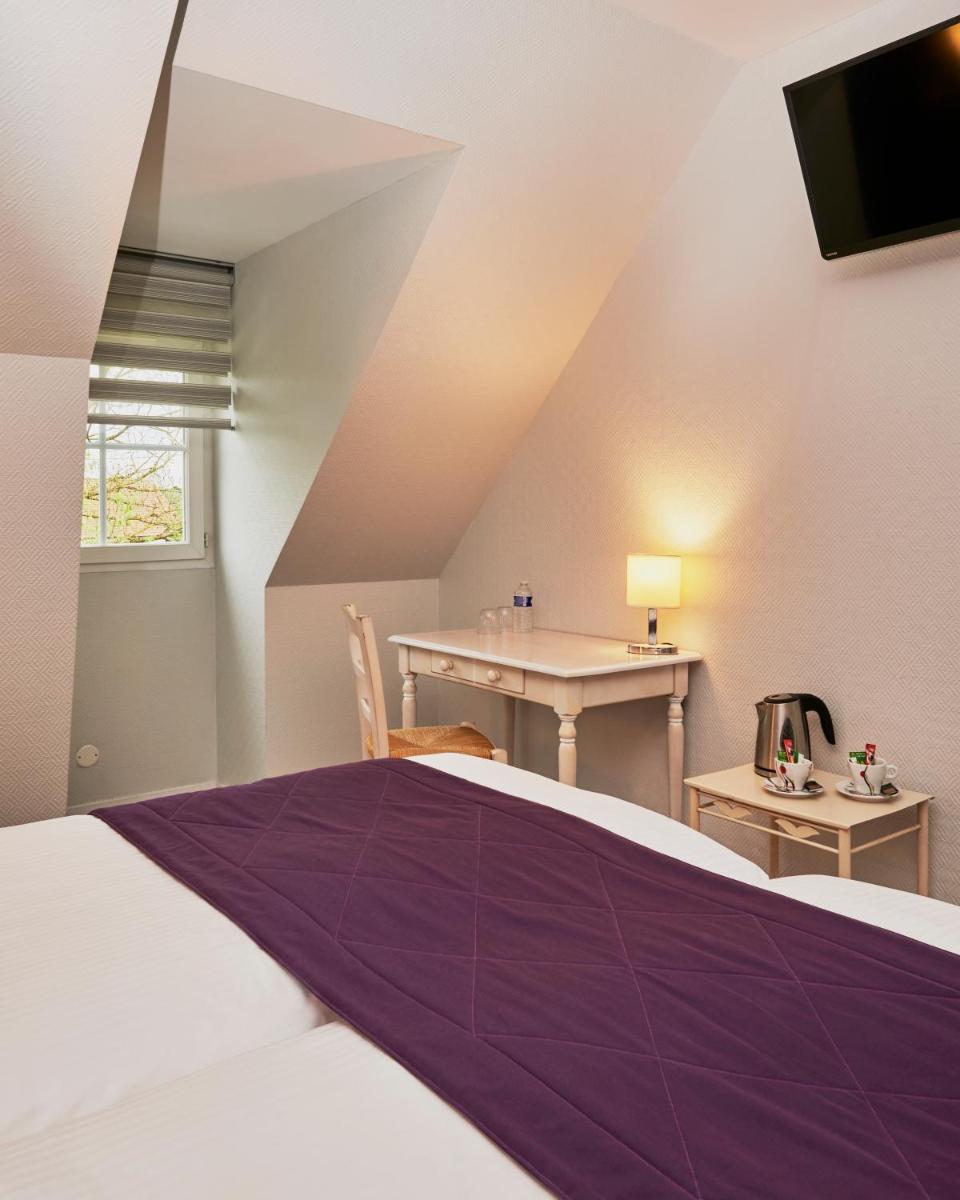 Un ou plusieurs lits dans un hébergement de l'établissement Hotel Spa Les Saules