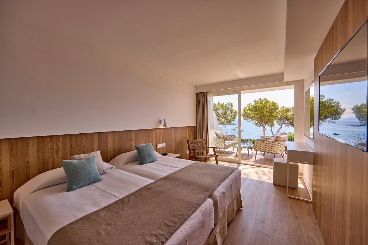 Cama o camas de una habitación en Aparthotel Ponent Mar