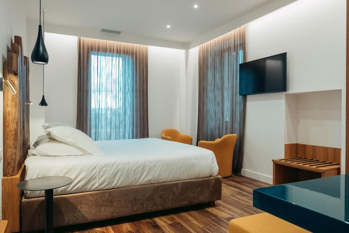 Un ou plusieurs lits dans un hébergement de l'établissement Hôtel Casale Olmia