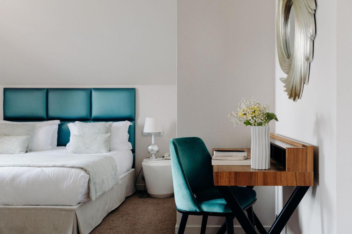 Un ou plusieurs lits dans un hébergement de l'établissement Hotel Le Cottage Bise