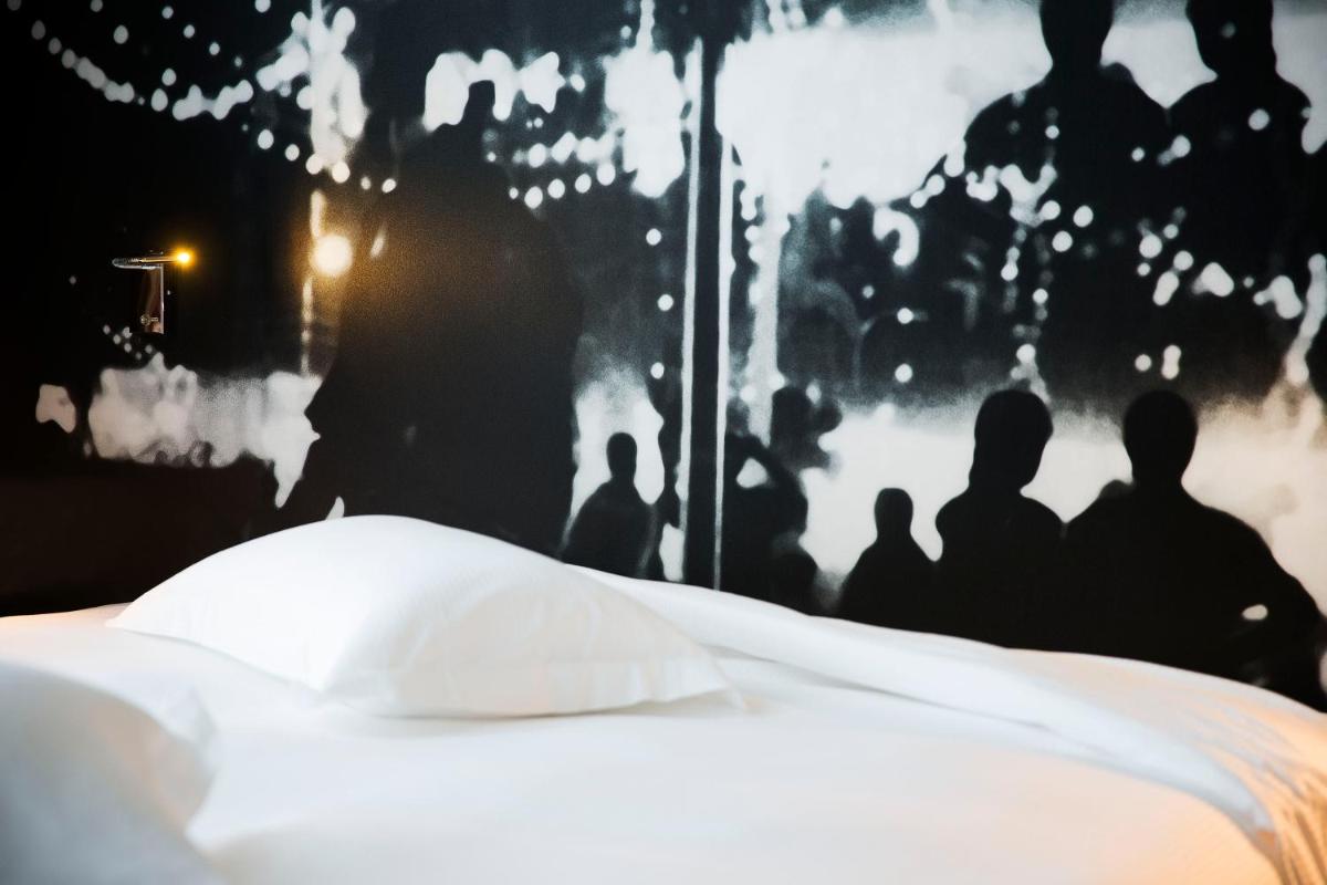 Un ou plusieurs lits dans un hébergement de l'établissement Hotel L’Antoine