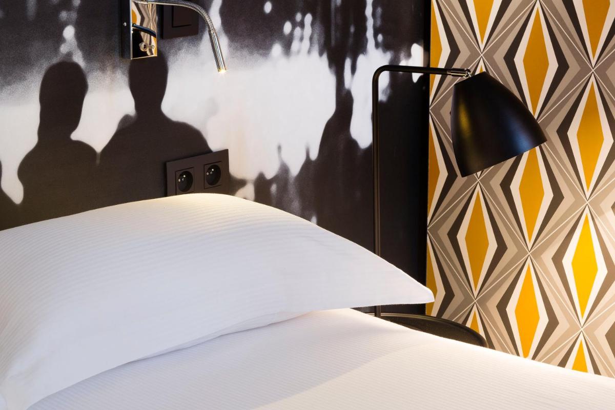 Un ou plusieurs lits dans un hébergement de l'établissement Hotel L’Antoine