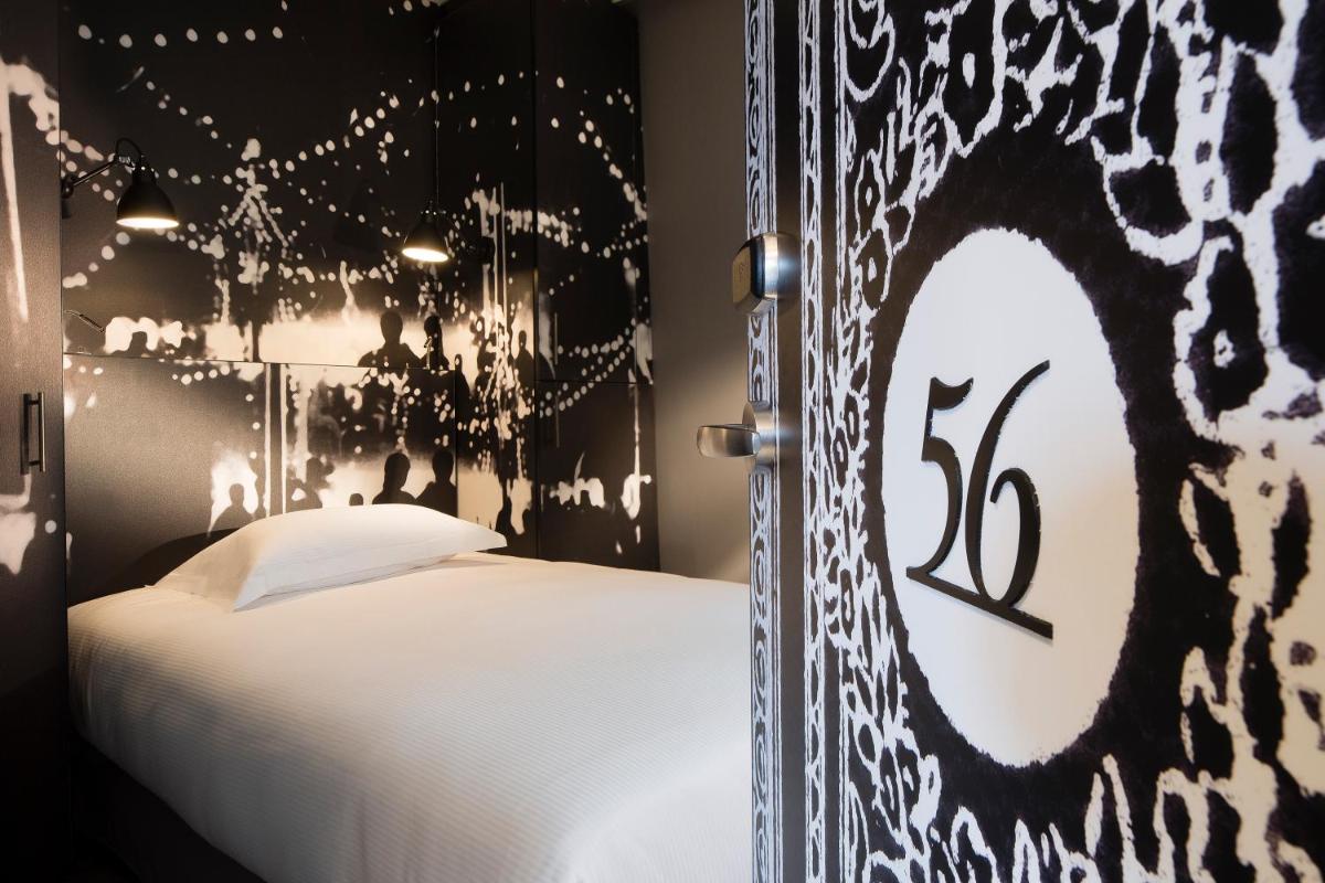 Un ou plusieurs lits dans un hébergement de l'établissement Hotel L’Antoine