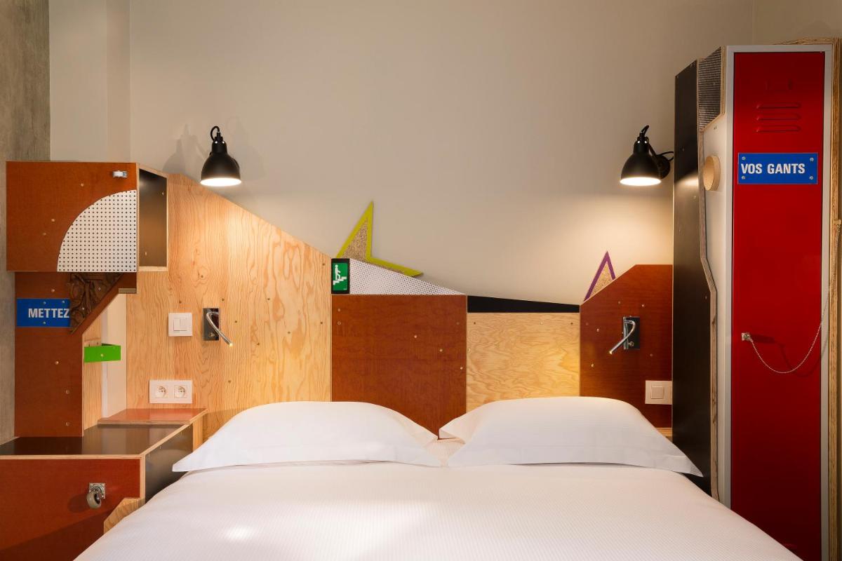 Un ou plusieurs lits dans un hébergement de l'établissement Hotel L’Antoine