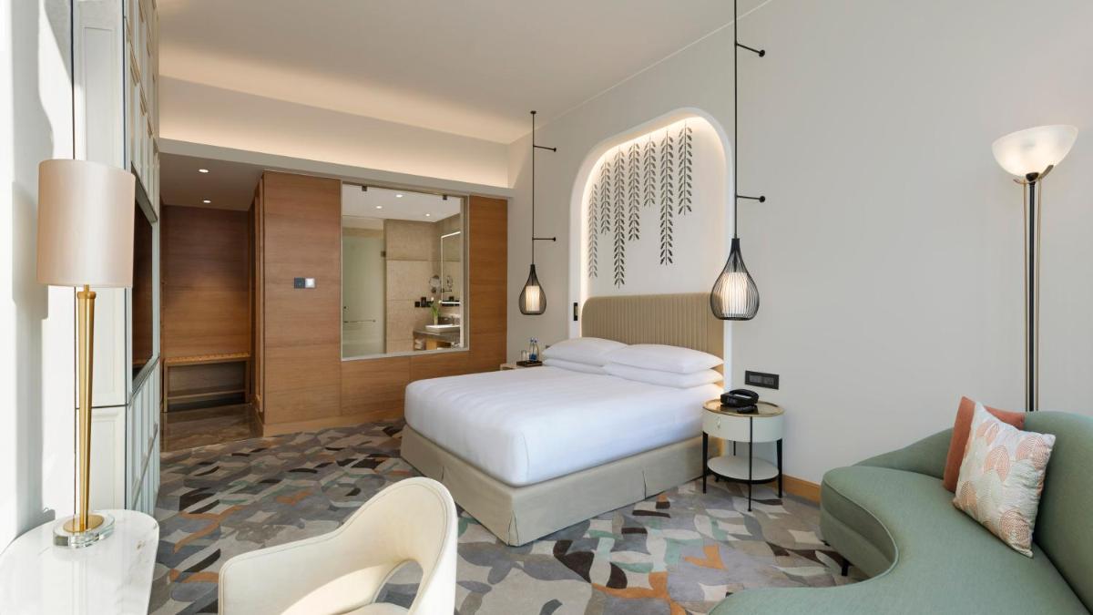 a bedroom with a white bed and a couch at InterContinental Jaipur Tonk Road by IHG in Jaipur