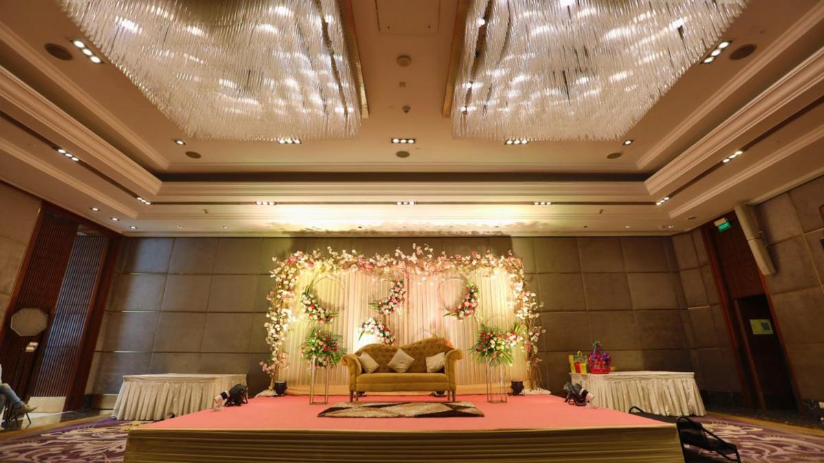 a room with a stage with a chair and lights at Holiday Inn New Delhi Mayur Vihar Noida by IHG in New Delhi a room with a stage with a chair and lights at Holiday Inn New Delhi Mayur Vihar Noida by IHG in New Delhi