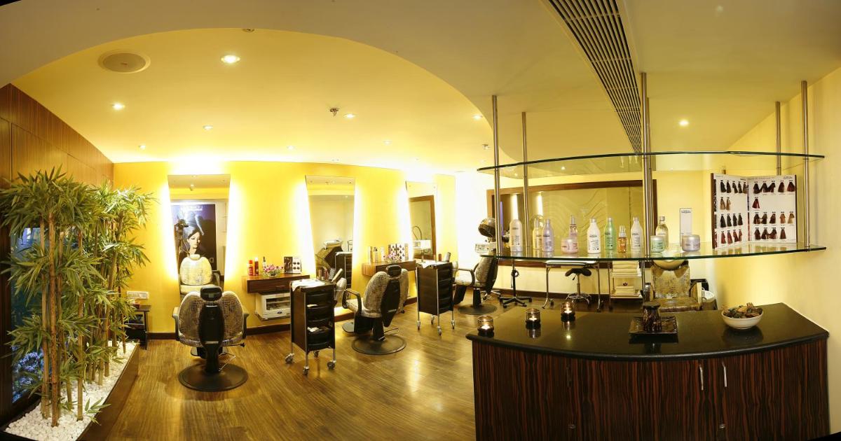 a hair salon with a bar in the middle of a room at Grand Chennai by GRT Hotels in Chennai