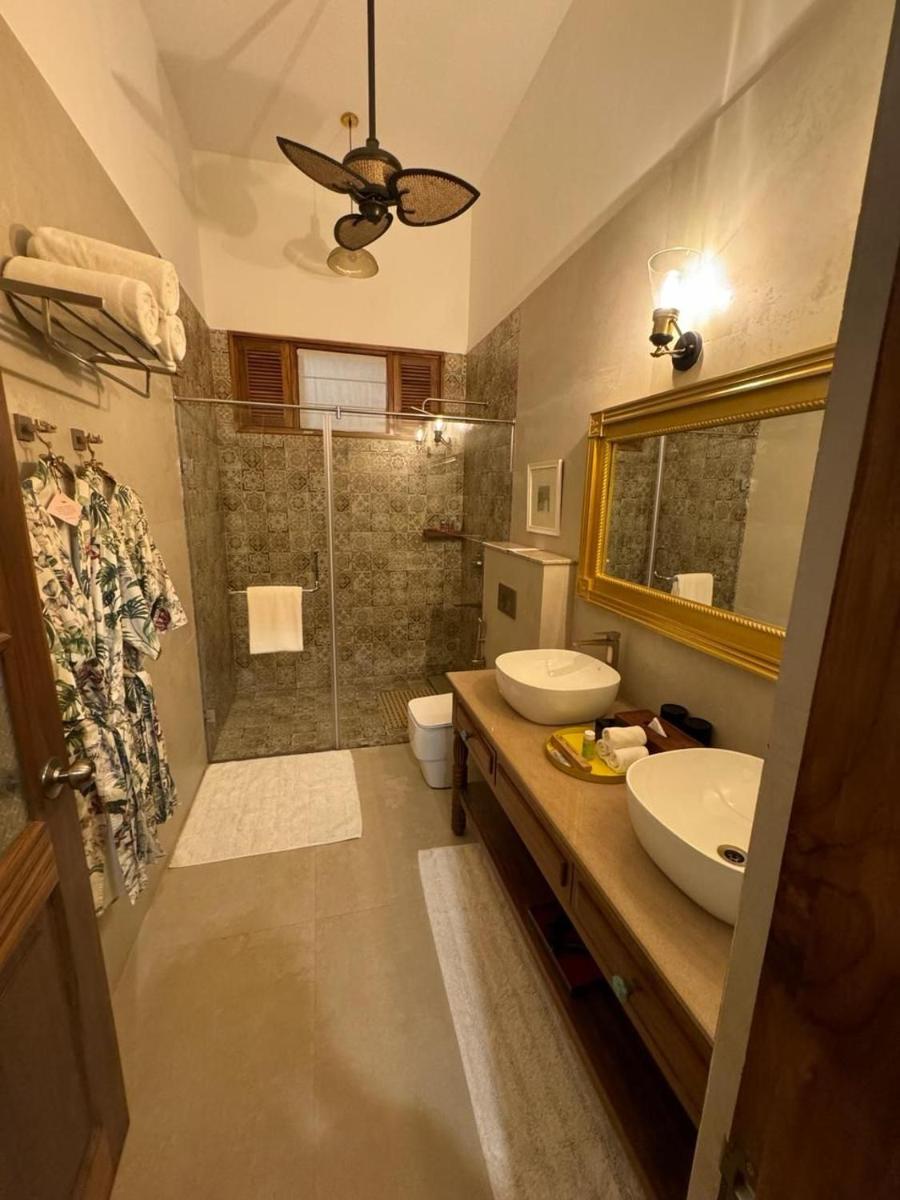 a bathroom with a sink and a shower at The Postcard Saligao in Calangute