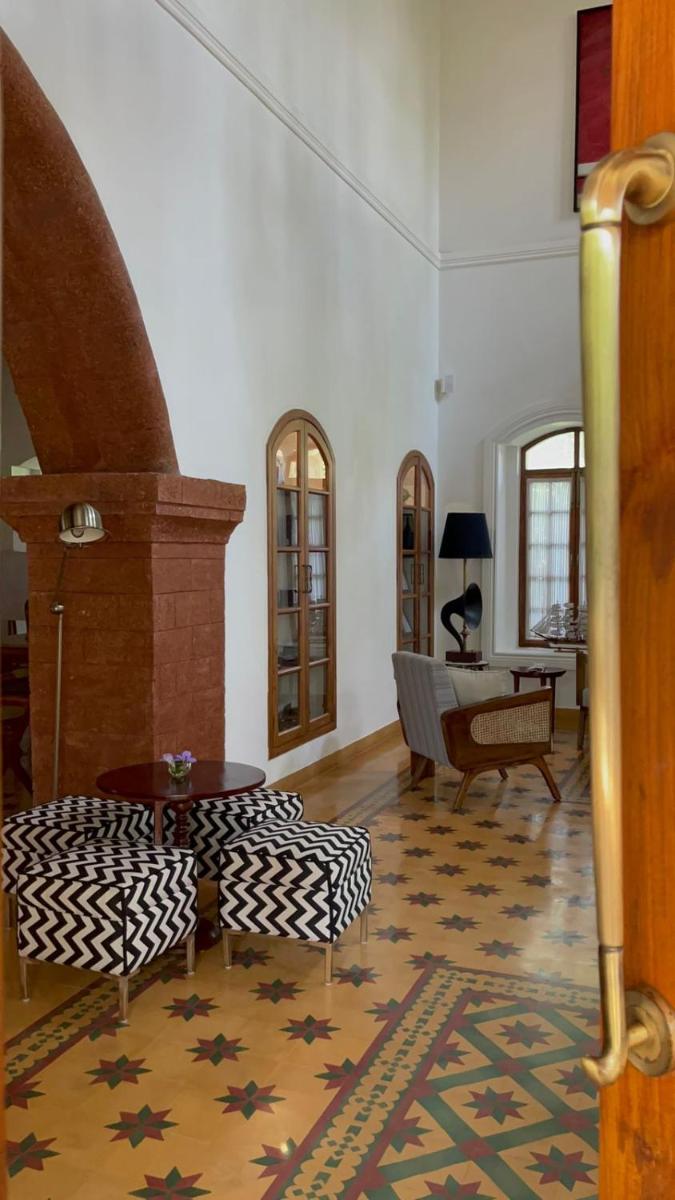 a living room with a couch and a table at The Postcard Saligao in Calangute