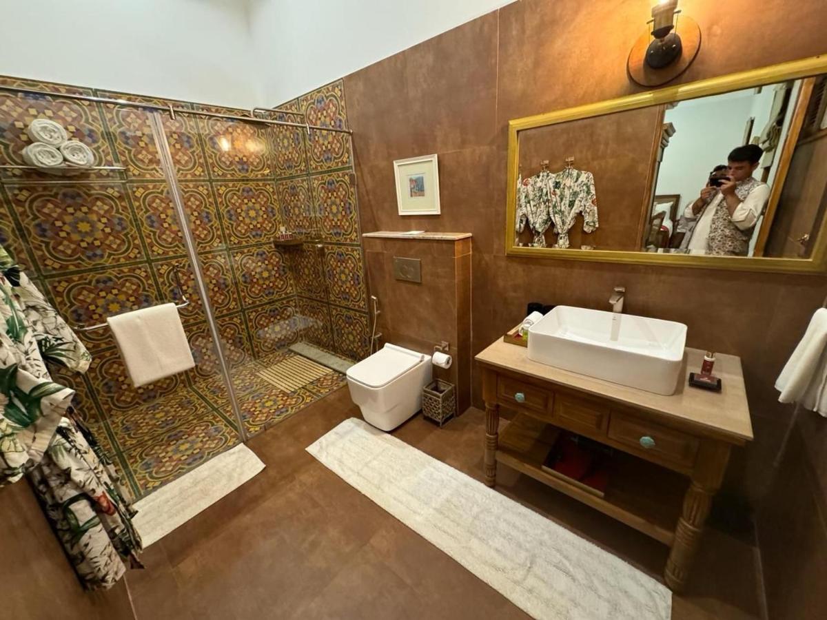 a bathroom with a shower and a sink and a toilet at The Postcard Saligao in Calangute