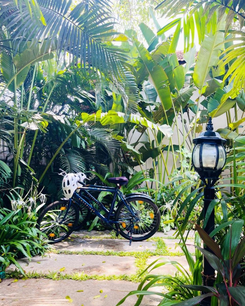 a bike is parked next to a street light at The Postcard Saligao in Calangute