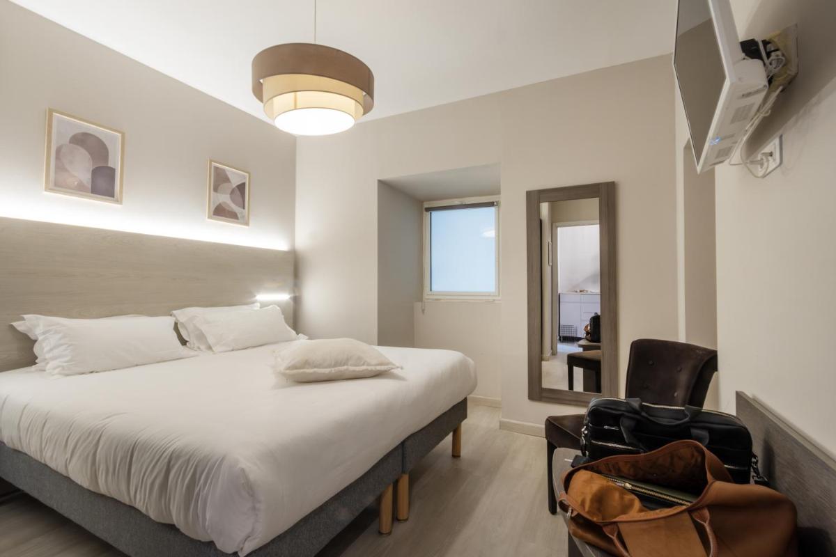 Un ou plusieurs lits dans un hébergement de l'établissement Hôtel Fesch & Spa