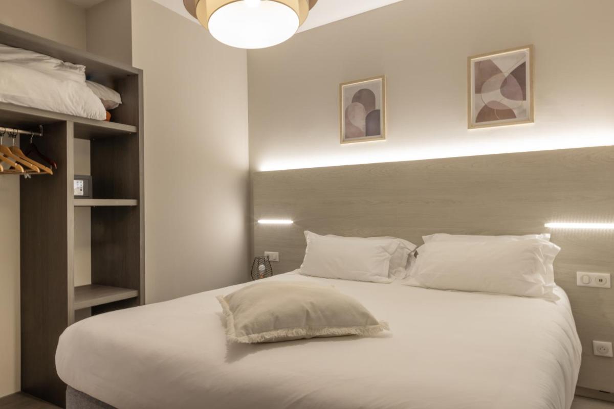 Un ou plusieurs lits dans un hébergement de l'établissement Hôtel Fesch & Spa