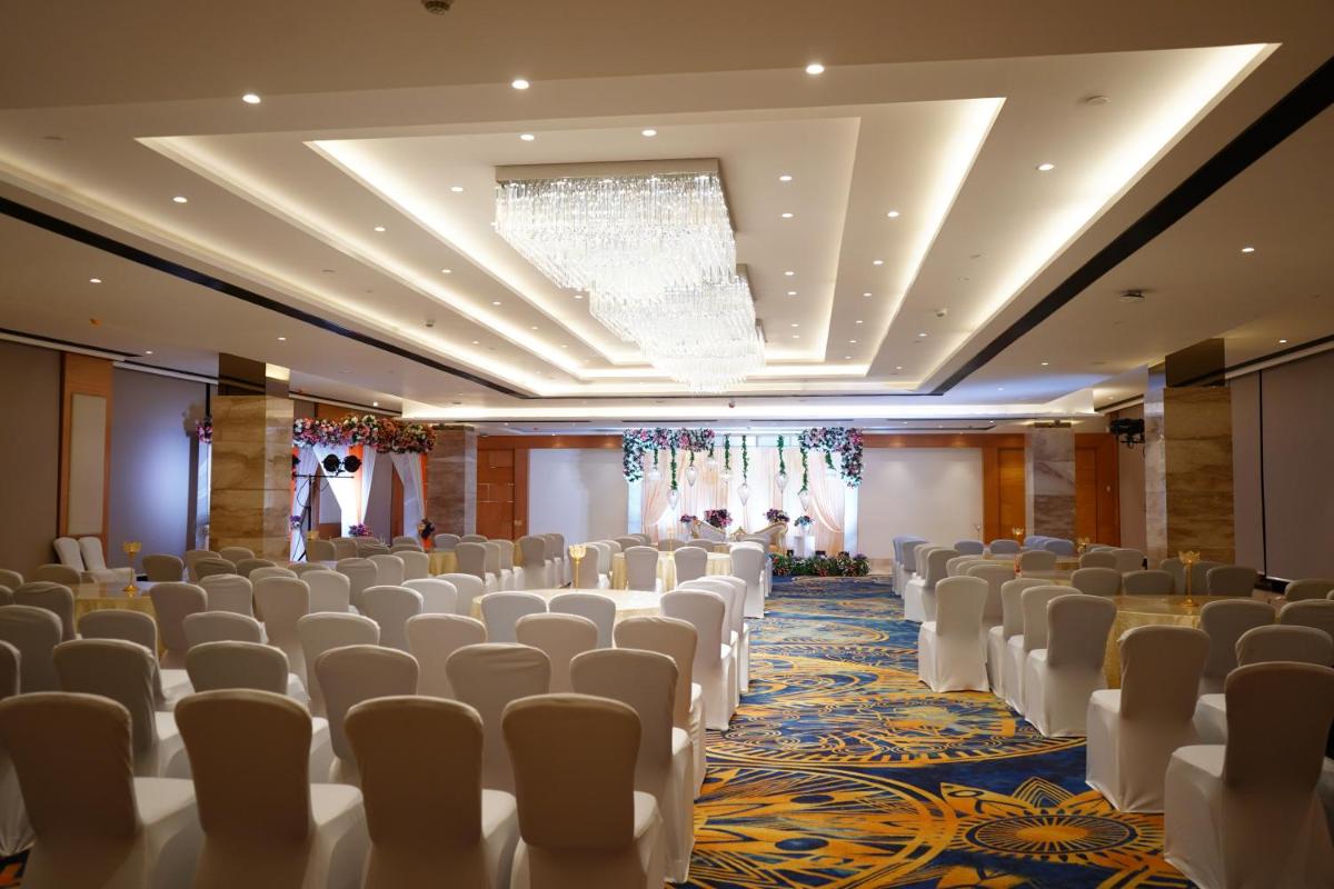 a room with rows of chairs and a chandelier at Hilton Garden Inn Pune Hinjawadi in Pune