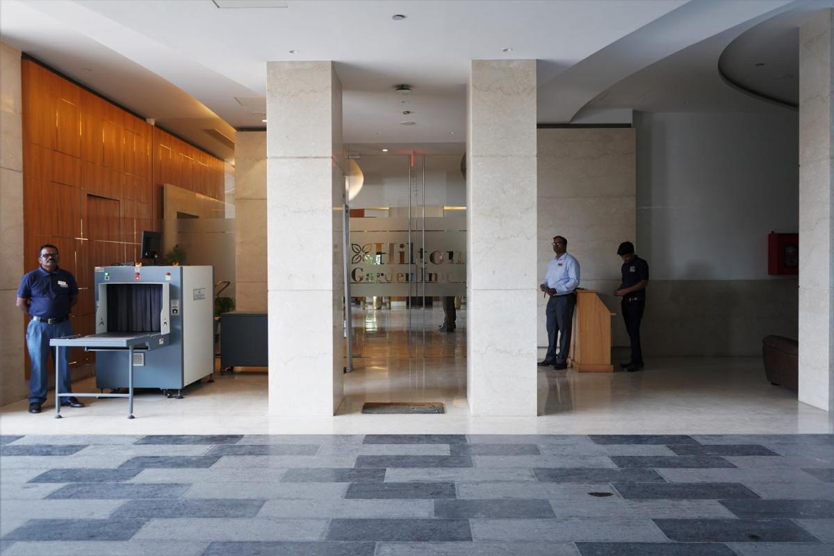a group of people standing in a lobby at Hilton Garden Inn Pune Hinjawadi in Pune