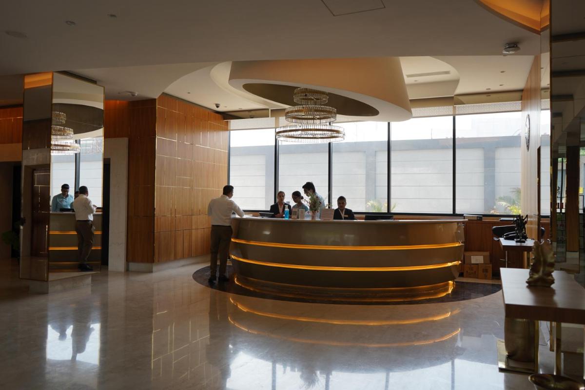 a lobby with people standing at a bar at Hilton Garden Inn Pune Hinjawadi in Pune