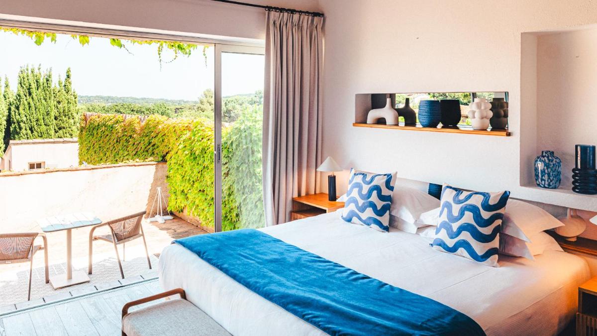 Un ou plusieurs lits dans un hébergement de l'établissement Hôtel La Mandarine