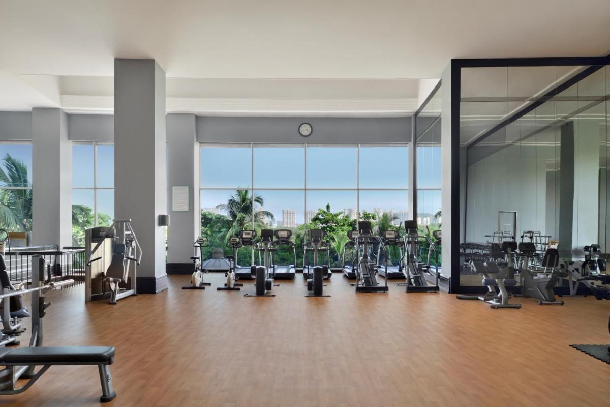 a gym with treadmills and cardio equipment in a building at Marriott Executive Apartment - Lakeside Chalet, Mumbai in Mumbai