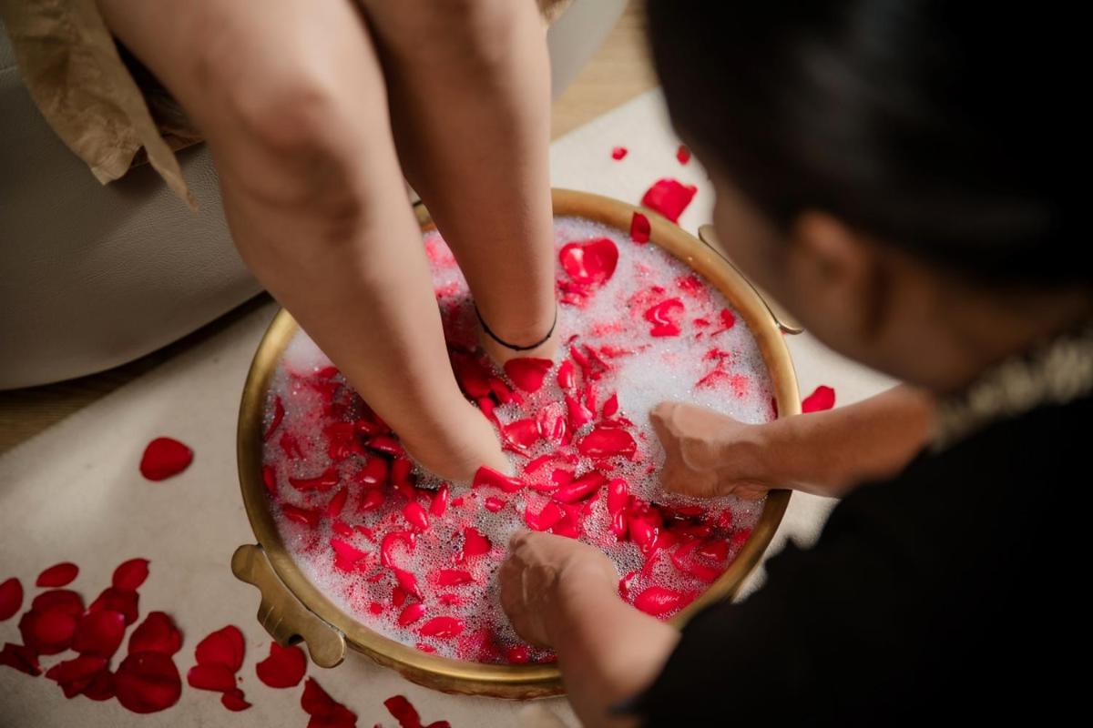 a woman is pouring red liquid into a bowl at Marriott Executive Apartment - Lakeside Chalet, Mumbai in Mumbai