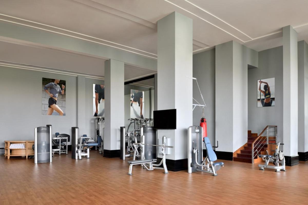 a room with chairs and paintings on the walls at Marriott Executive Apartment - Lakeside Chalet, Mumbai in Mumbai