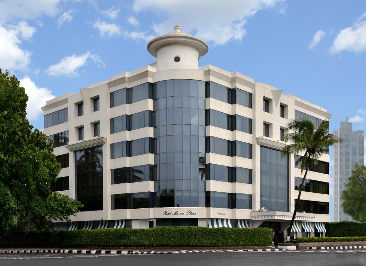 a white building with a clock tower on top of it at Hotel Marine Plaza in Mumbai