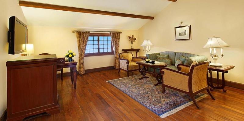 a living room with a couch and a table at The Oberoi Cecil in Shimla