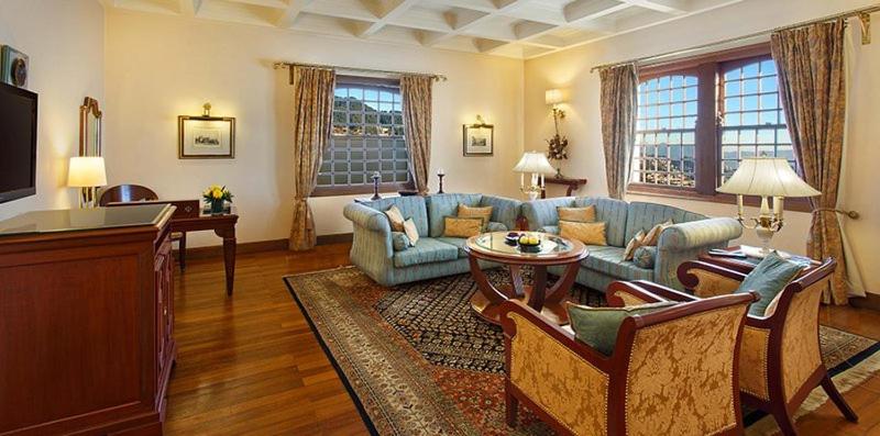 a living room with a couch and a table at The Oberoi Cecil in Shimla