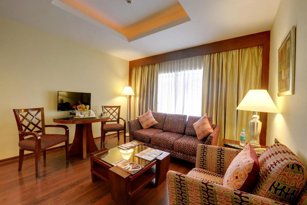 a living room with a couch and a table at Fortune Select JP Cosmos, Bengaluru - Member ITC Hotels' Group in Bengaluru
