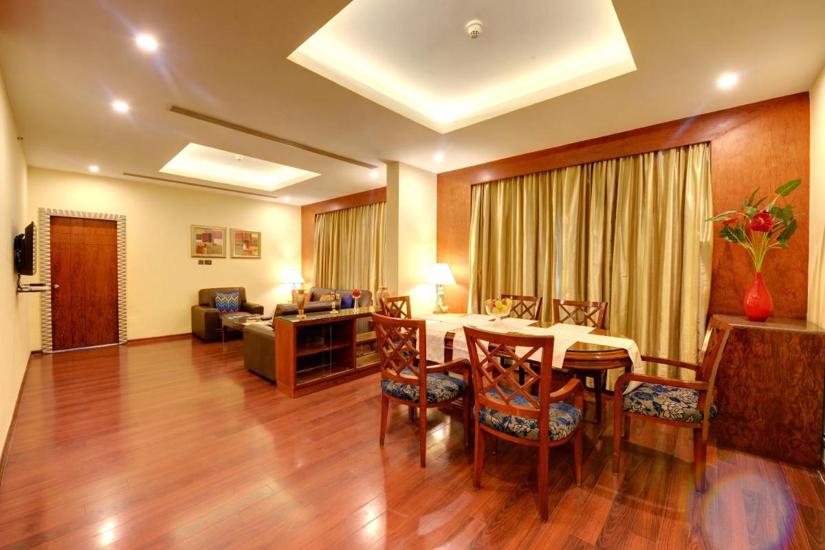 a living room with a table and chairs and a couch at Fortune Select JP Cosmos, Bengaluru - Member ITC Hotels' Group in Bengaluru