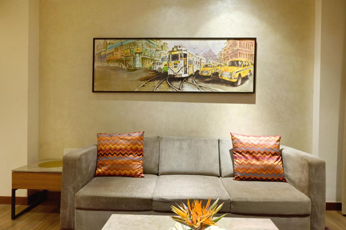 a living room with a couch and a painting on the wall at Vivanta Kolkata EM Bypass in Kolkata