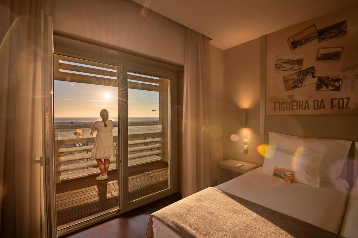Uma cama ou camas num quarto em Vila Gale Collection Figueira da Foz