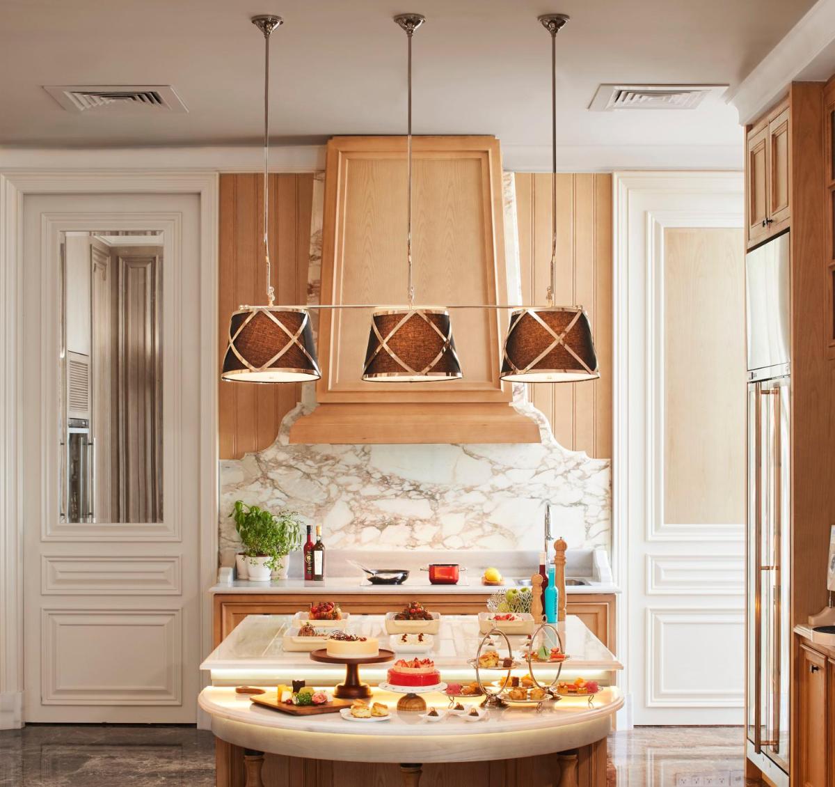 a kitchen with a island with food on it at The Ritz-Carlton, Pune in Pune