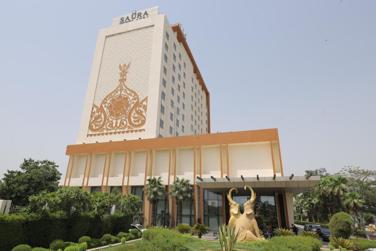 a building with two statues in front of it at Saura Hotel, Agra - A Club Mahindra Associate in Agra