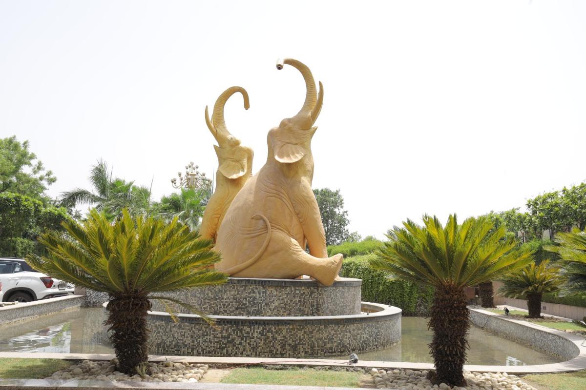 a statue of a monkey sitting in a fountain at Saura Hotel, Agra - A Club Mahindra Associate in Agra